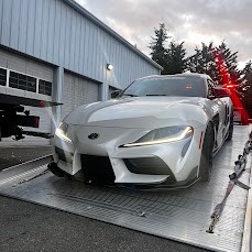 Low sports car being loaded onto a SafeTow flatbed